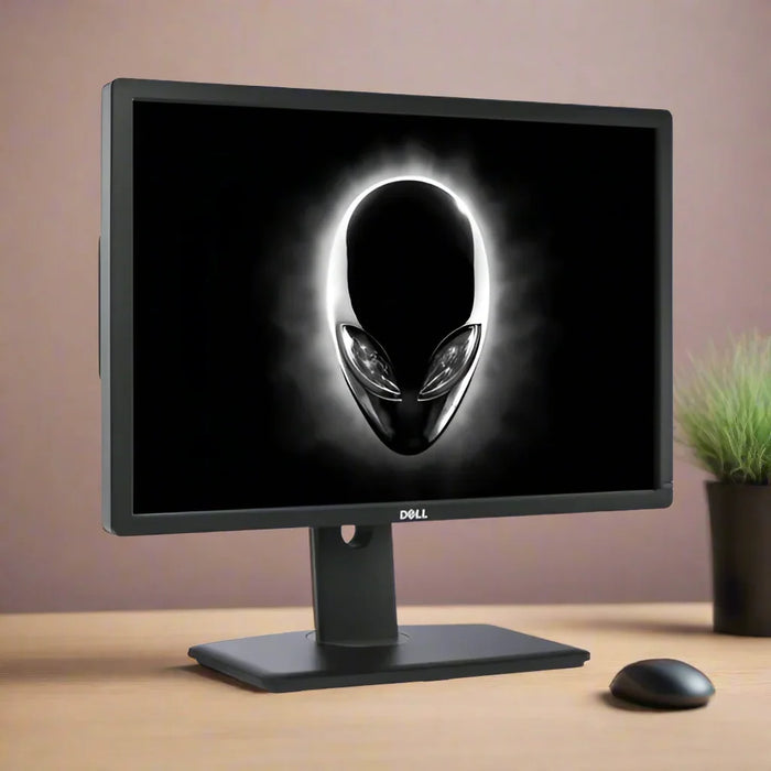 A refurbished Dell UltraSharp U2413 IPS 24" monitor (1920x1200, 16:10) sits on a wooden desk, displaying a glowing stylized alien logo. Next to it are a wireless mouse and potted plant against a softly blurred background.